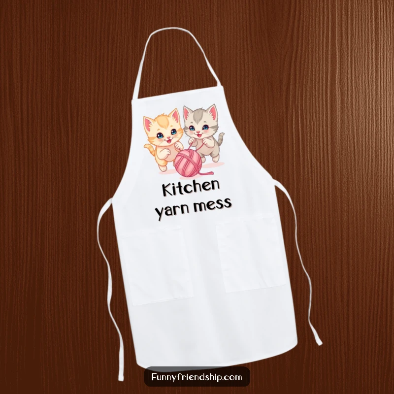Funny playful kittens chasing a bouncing ball of yarn together on a cute kitchen apron, a playful cartoon accessory